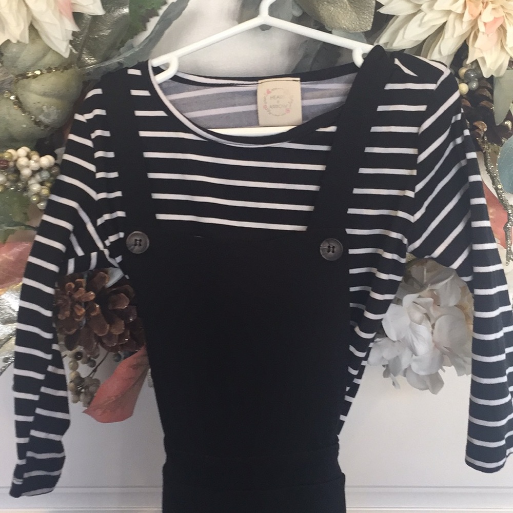 Overalls with striped shirt.
